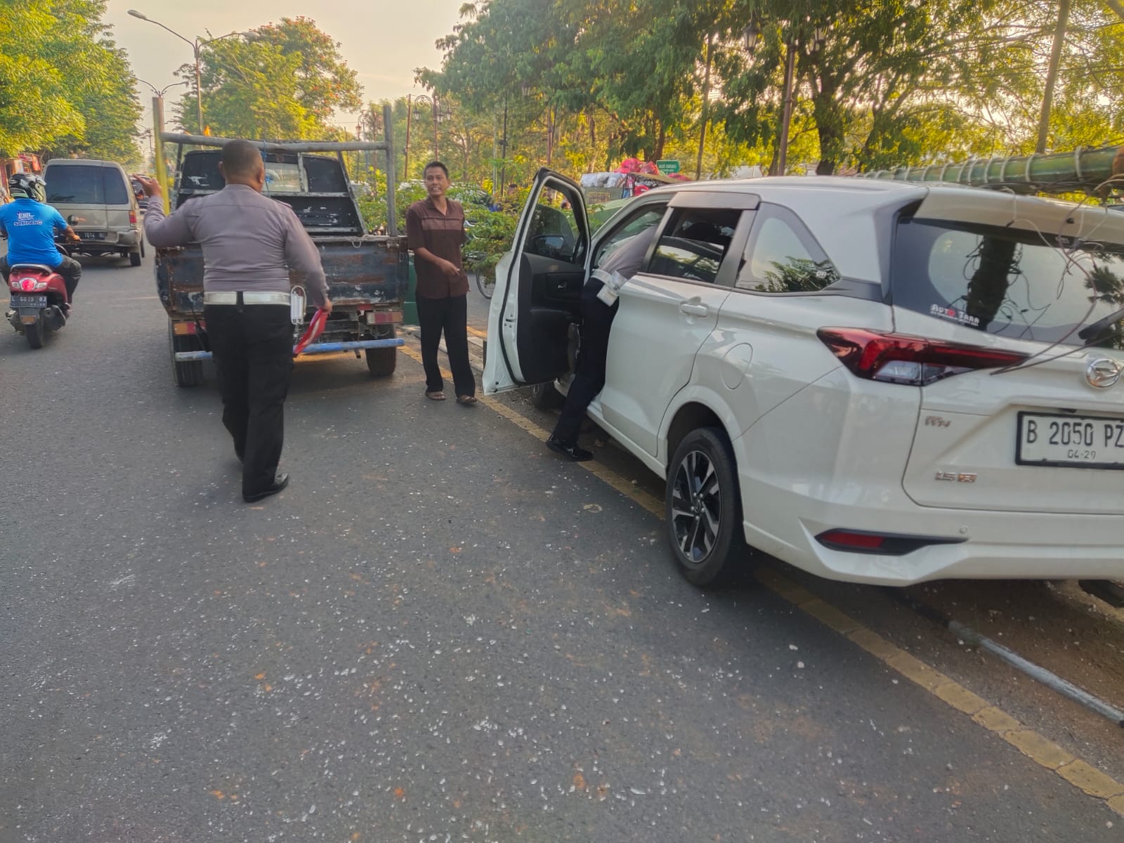 Mobil minibus warna putih menabrak pot bunga dan tiang listrik PJU di Pamekasan 